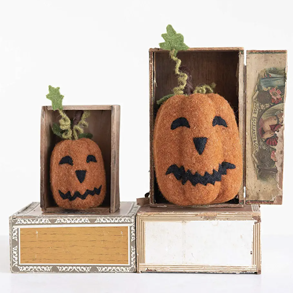 Two orange felt jack-o'-lanterns displayed inside vintage wooden matchboxes.