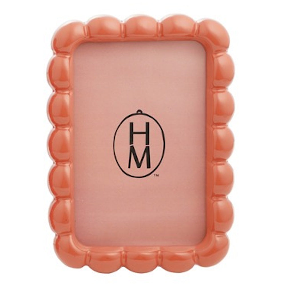 Glossy orange scalloped resin photo frame with a rounded, bubbly texture and a light pink insert.