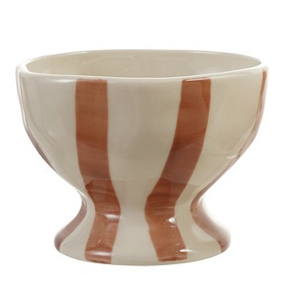 Cream footed ceramic bowl with thick, hand-painted terracotta-orange vertical stripes set against a white backdrop.