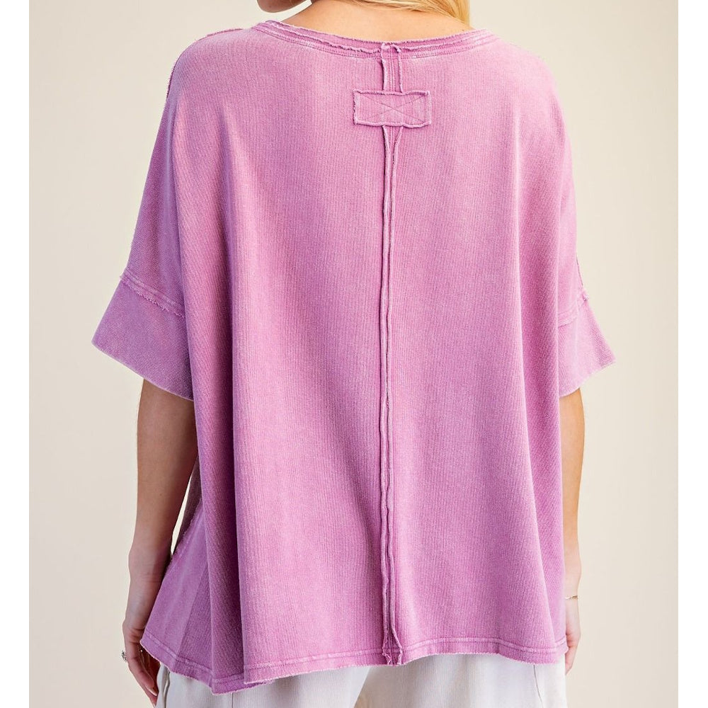 Back view of an orchid pink short-sleeved washed terry knit top featuring vertical seam detailing.