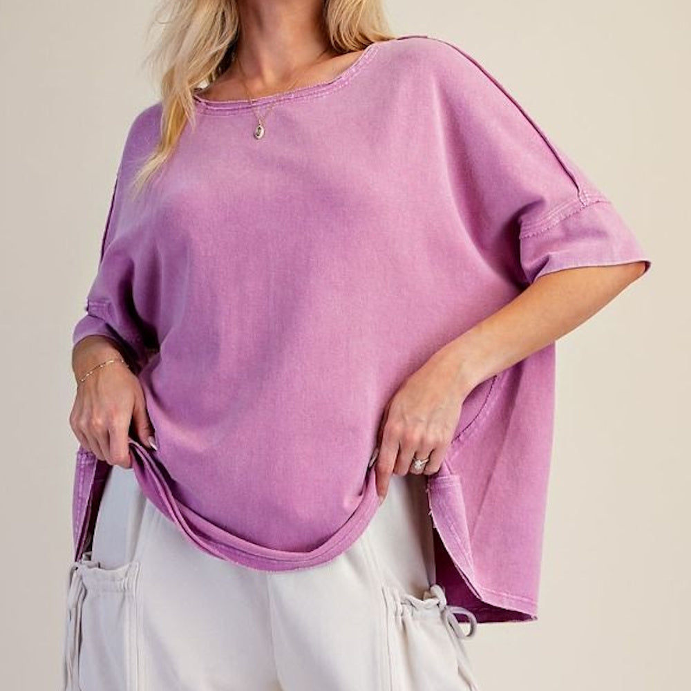 Casual washed orchid short-sleeve terry knit top worn with light pants.