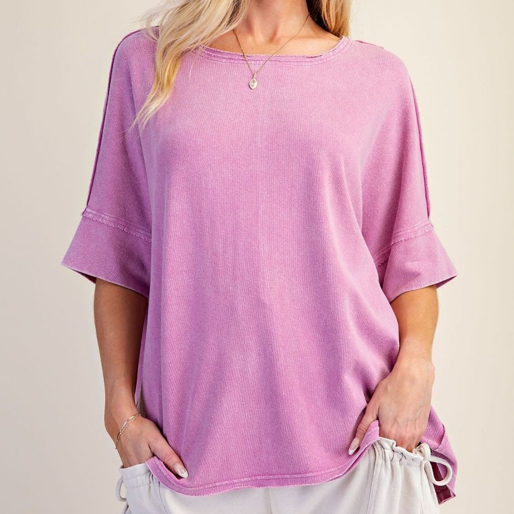 Short-sleeved orchid purple relaxed-fit knit top with washed finish and raw seam details.