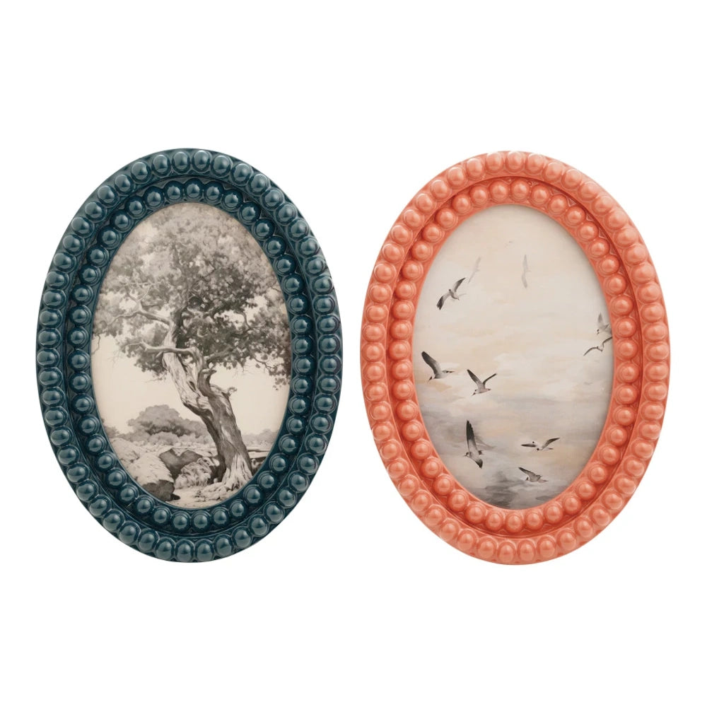 Oval resin bobbin photo frames in teal and coral with beaded textures, featuring vintage tree and bird art.