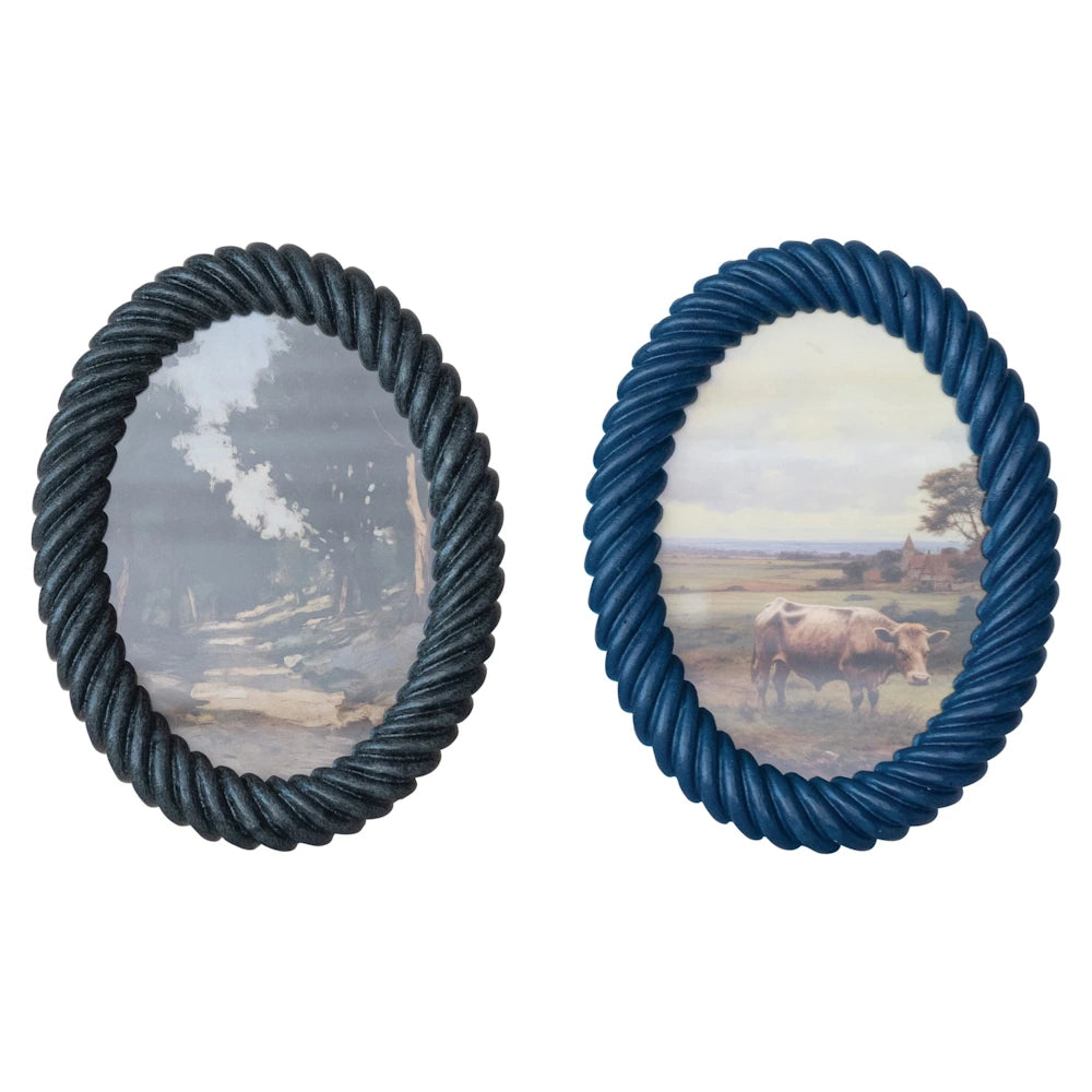 Two oval picture frames with a twisted rope-texture border, one in charcoal grey and one in navy blue, containing rural art.