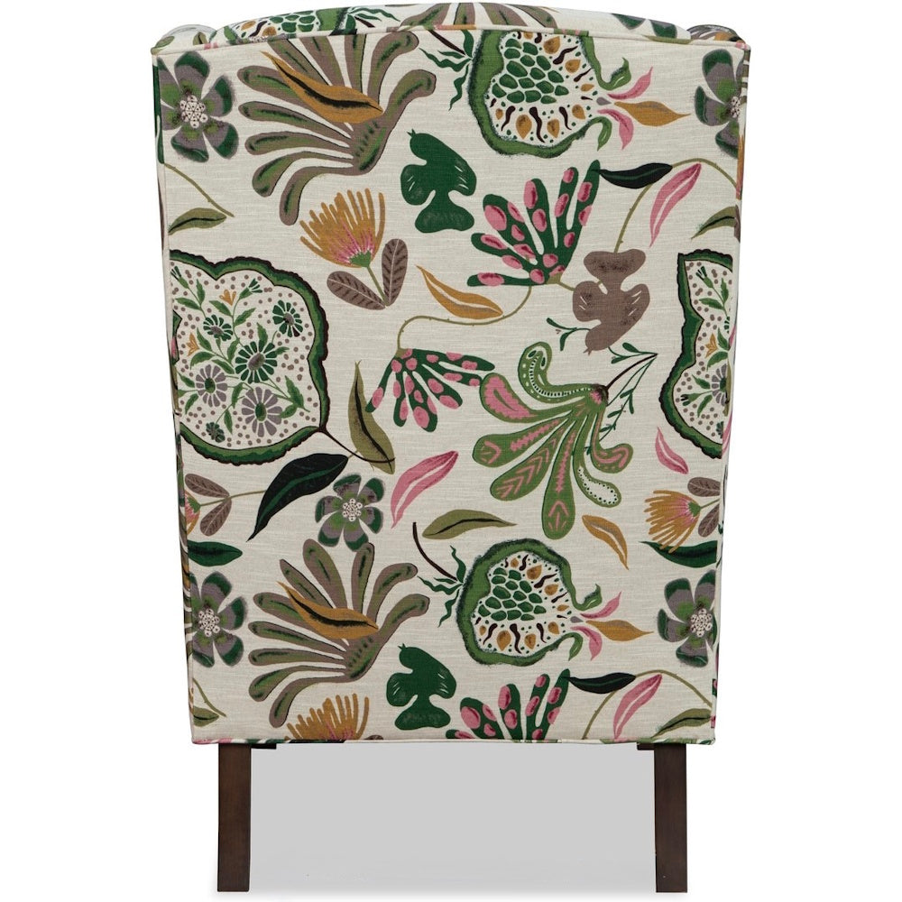 Back view of an armchair featuring a colorful botanical floral print fabric with dark brown legs.