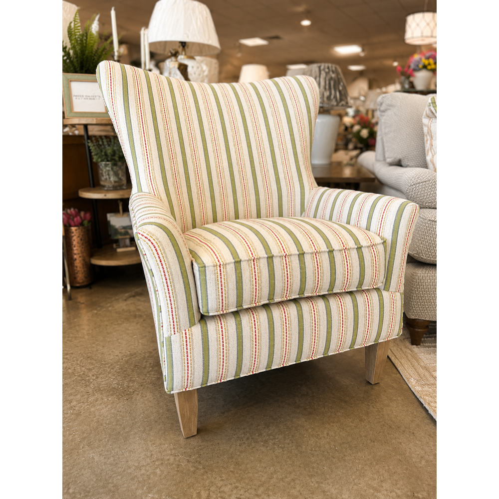 Striped wingback accent chair with green, red, and cream vertical stripes on light wood legs.
