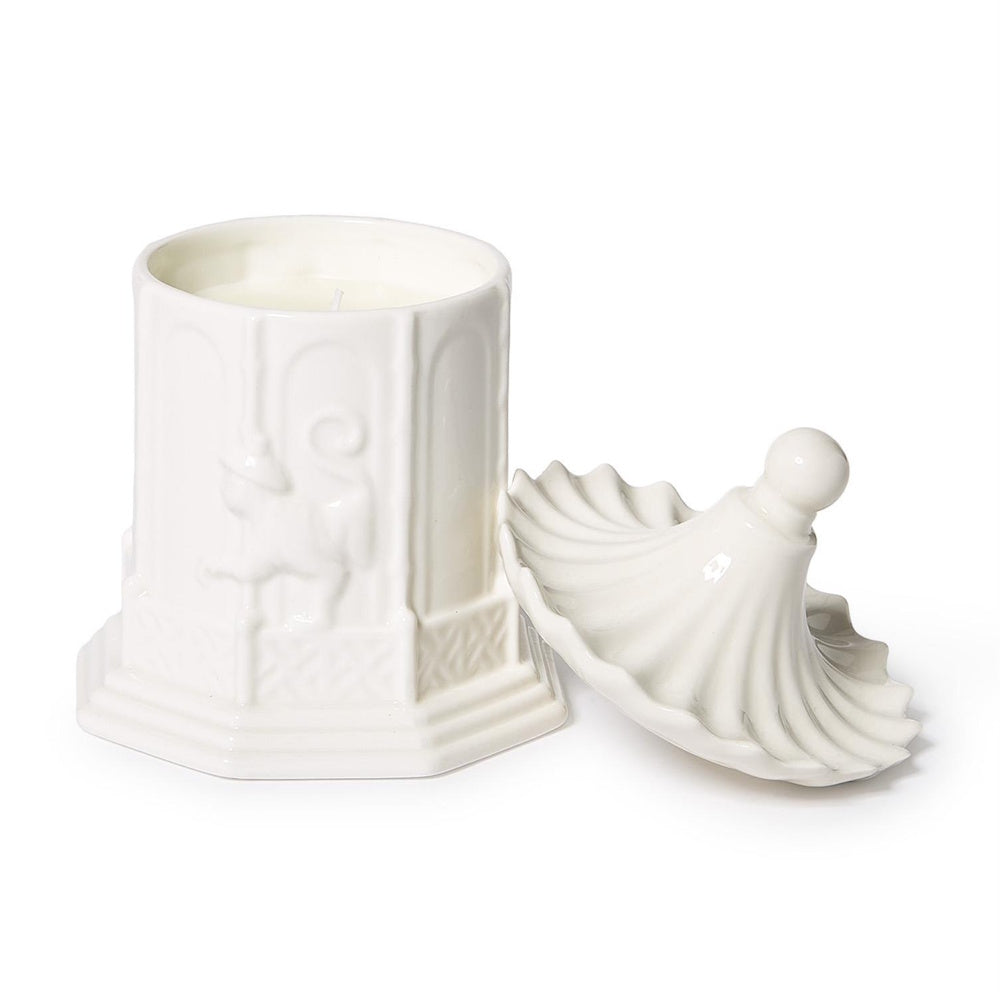 White ceramic pagoda-style candle jar with relief carvings and an unattached scalloped lid.