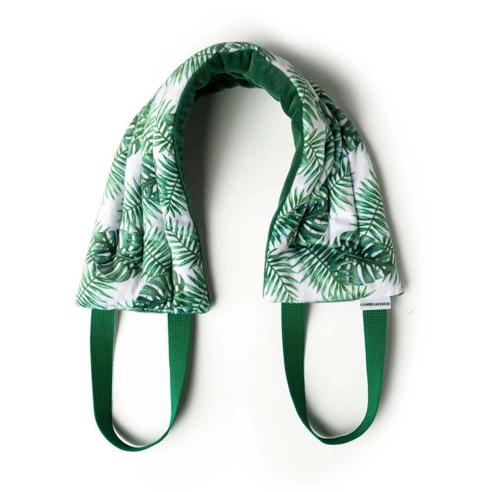 Lemon Lavender palm leaf print heated neck wrap with green handles on a white background for soothing heat therapy.