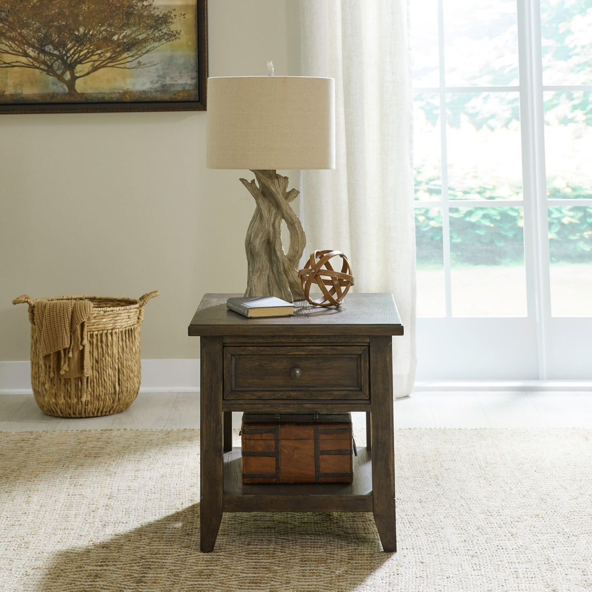 Rustic dark wood end table in cozy living room with drawer storage, open shelf and decorative lamp display.
