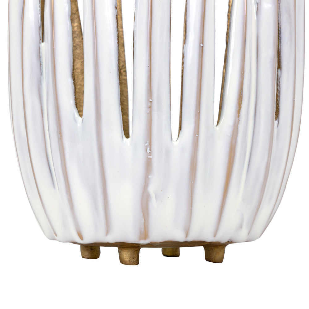 Close-up of a white and gold ceramic candle holder base featuring a textured, ribbed design and small gold feet.