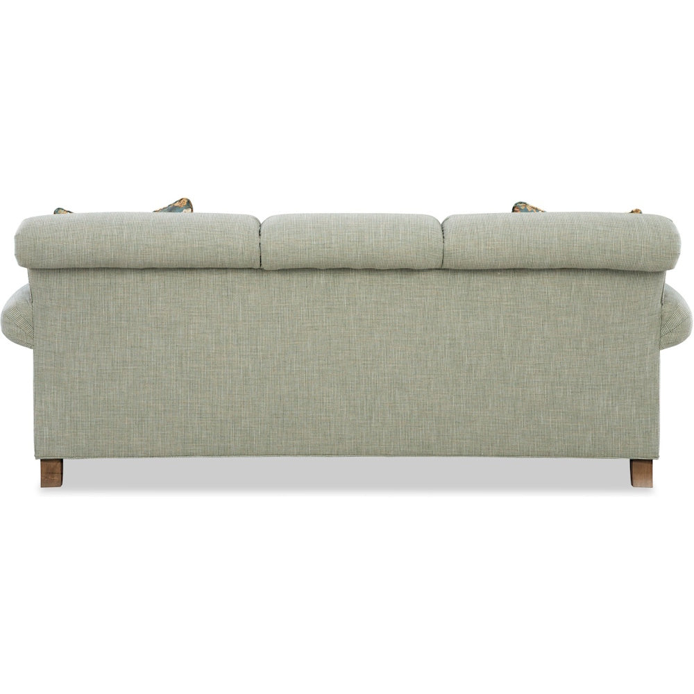 Back view of a light green textured fabric sofa with rolled tight back and wooden legs.