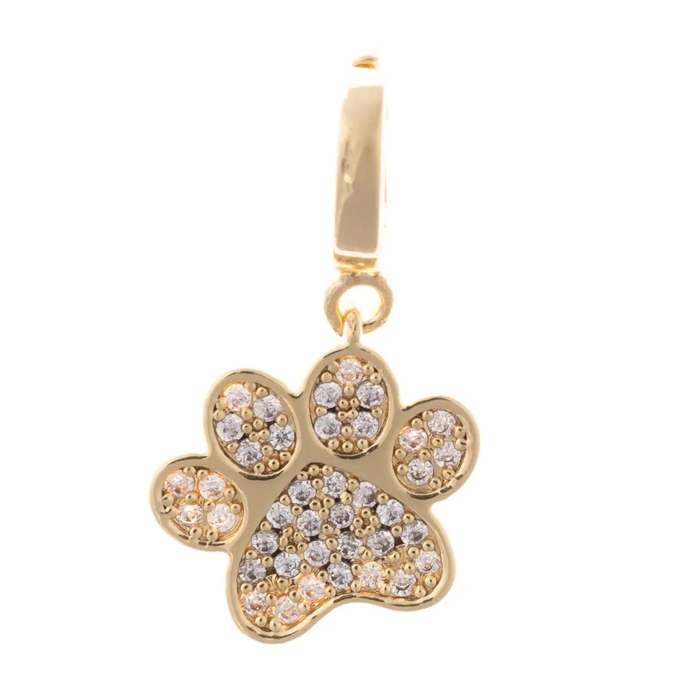 Gold paw print charm pave-set with sparkling clear crystal accents on the pad and toe prints.