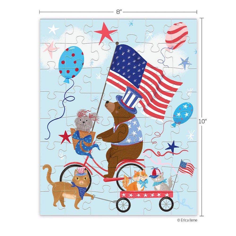 Illustration of a bear riding a bicycle with a dog and cats in a parade, featuring American flags and balloons.