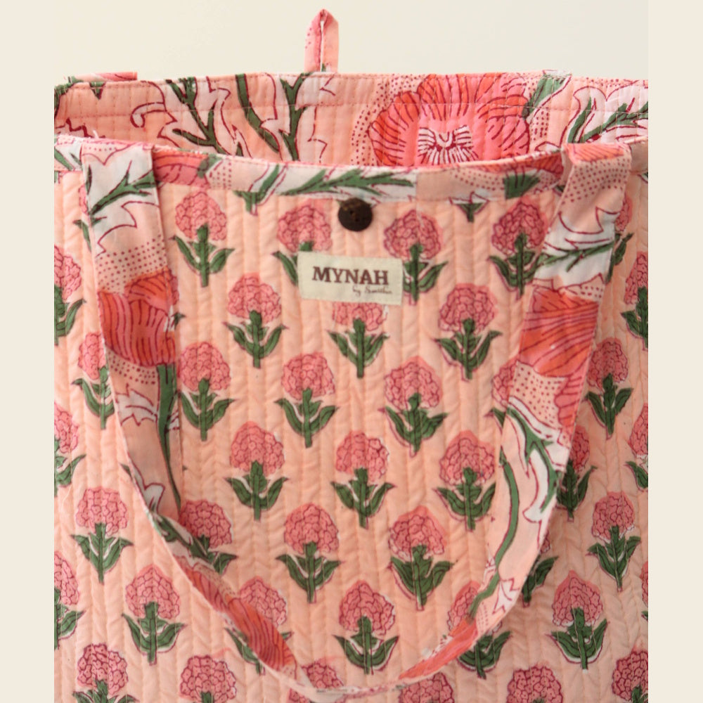 Mynah peach poppies print quilted reversible tote bag with floral patterns and wood button closure.