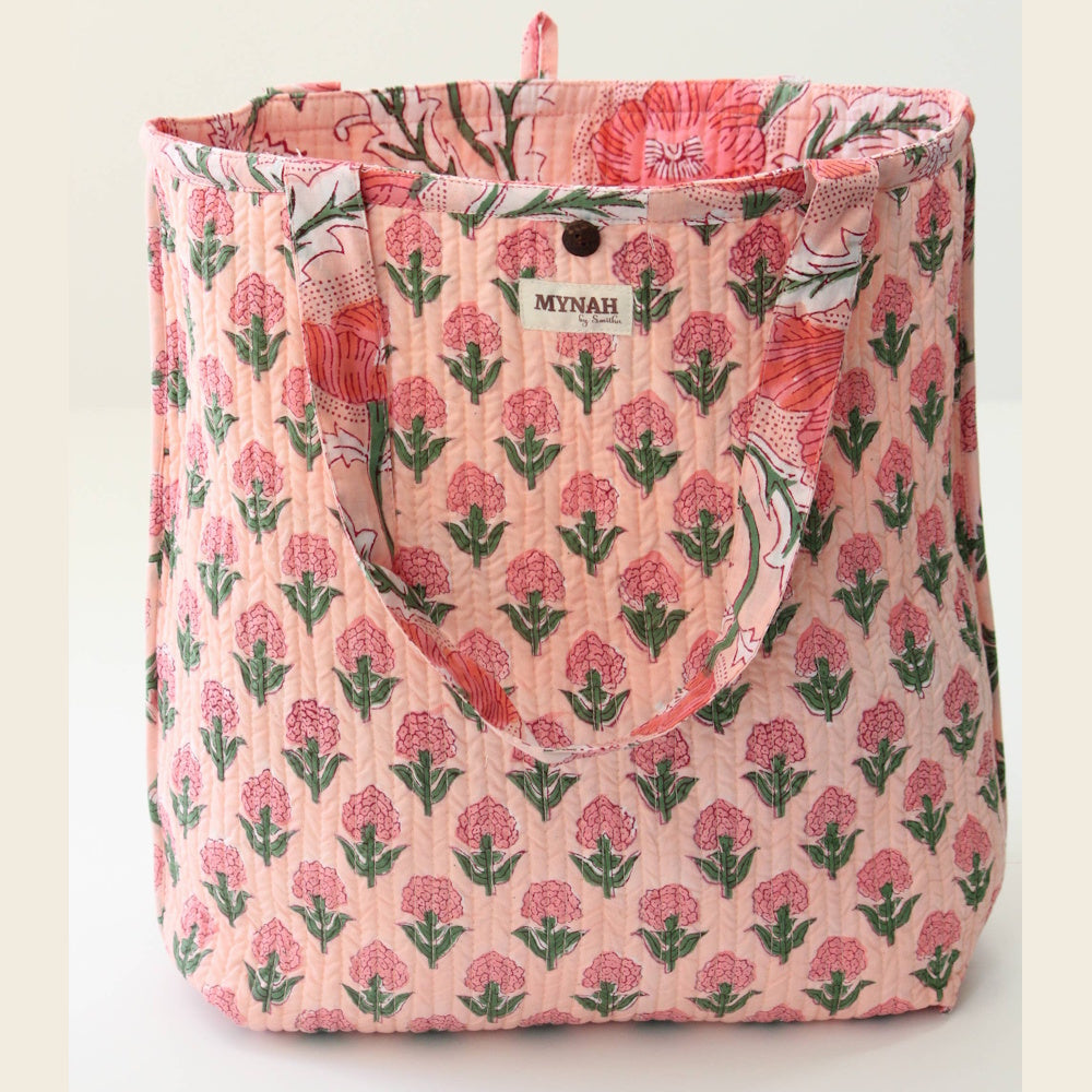 MYNAH by Smitha reversible quilted tote bag with a pink and peach poppy floral block print pattern and shoulder straps.