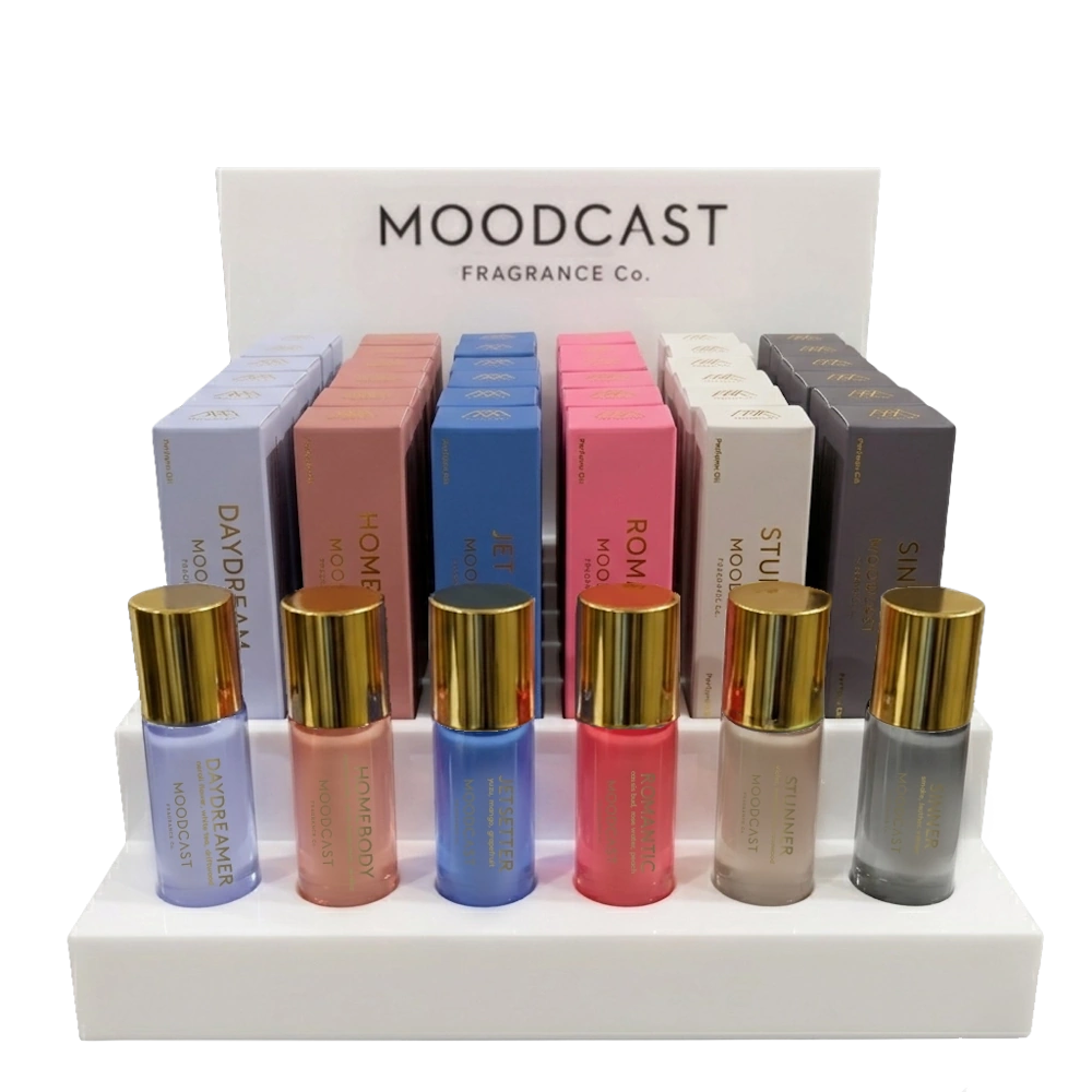 Moodcast display stand featuring colorful perfume mist bottles with gold caps in front of matching boxed sets.