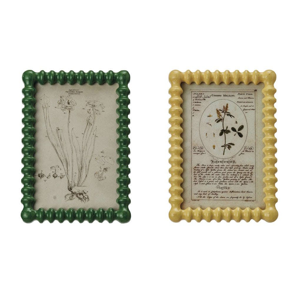 Two rectangular, bumpy-textured picture frames, one green and one yellow, holding vintage botanical illustrations.