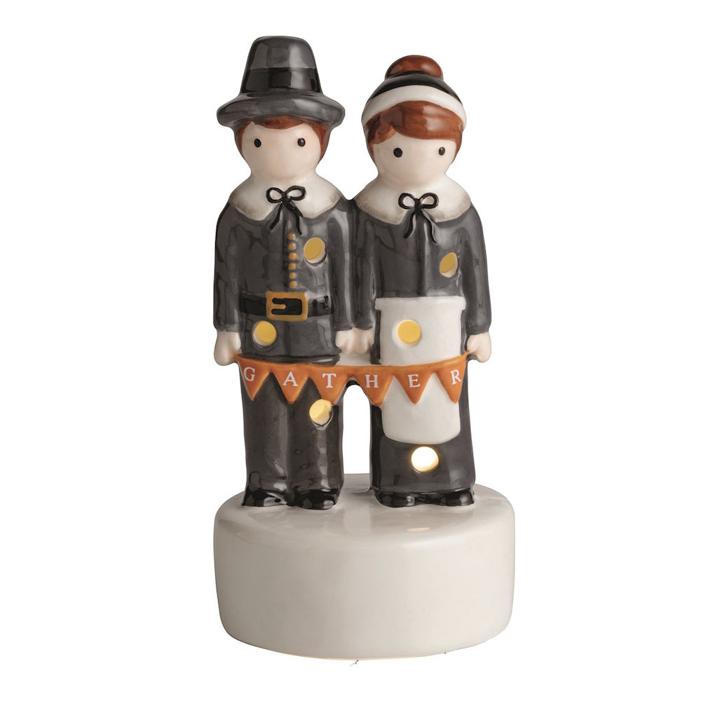 Ceramic light-up Pilgrim couple figurine holding a banner that says "GATHER".