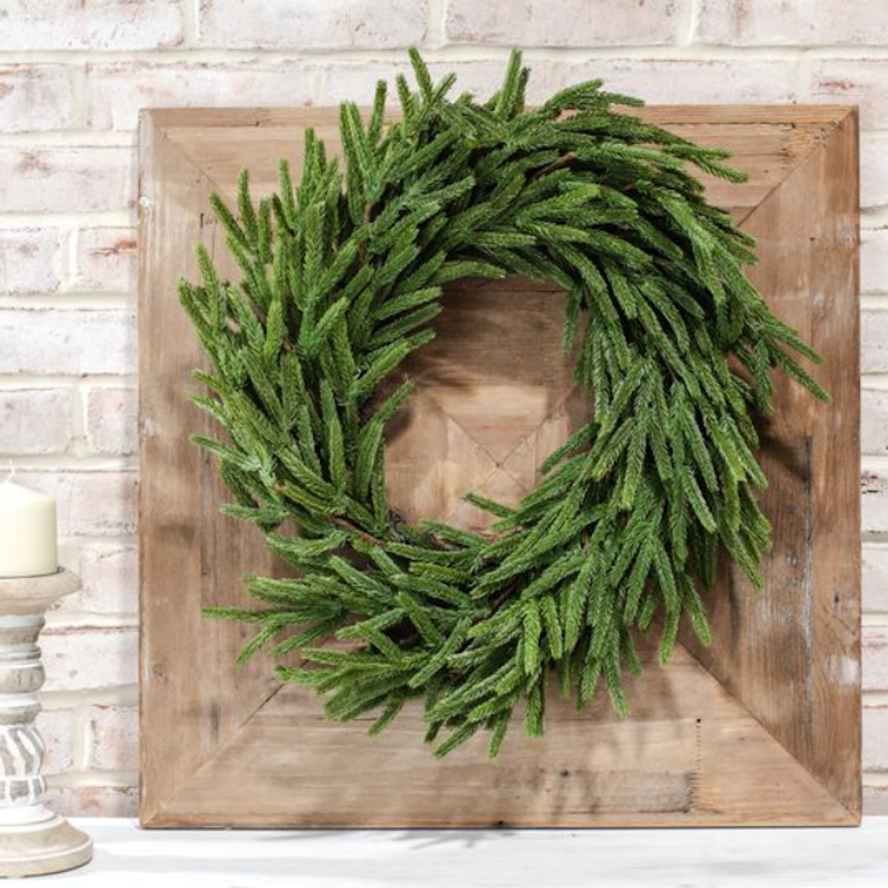 Lush artificial green pine wreath mounted on a rustic square wooden frame.