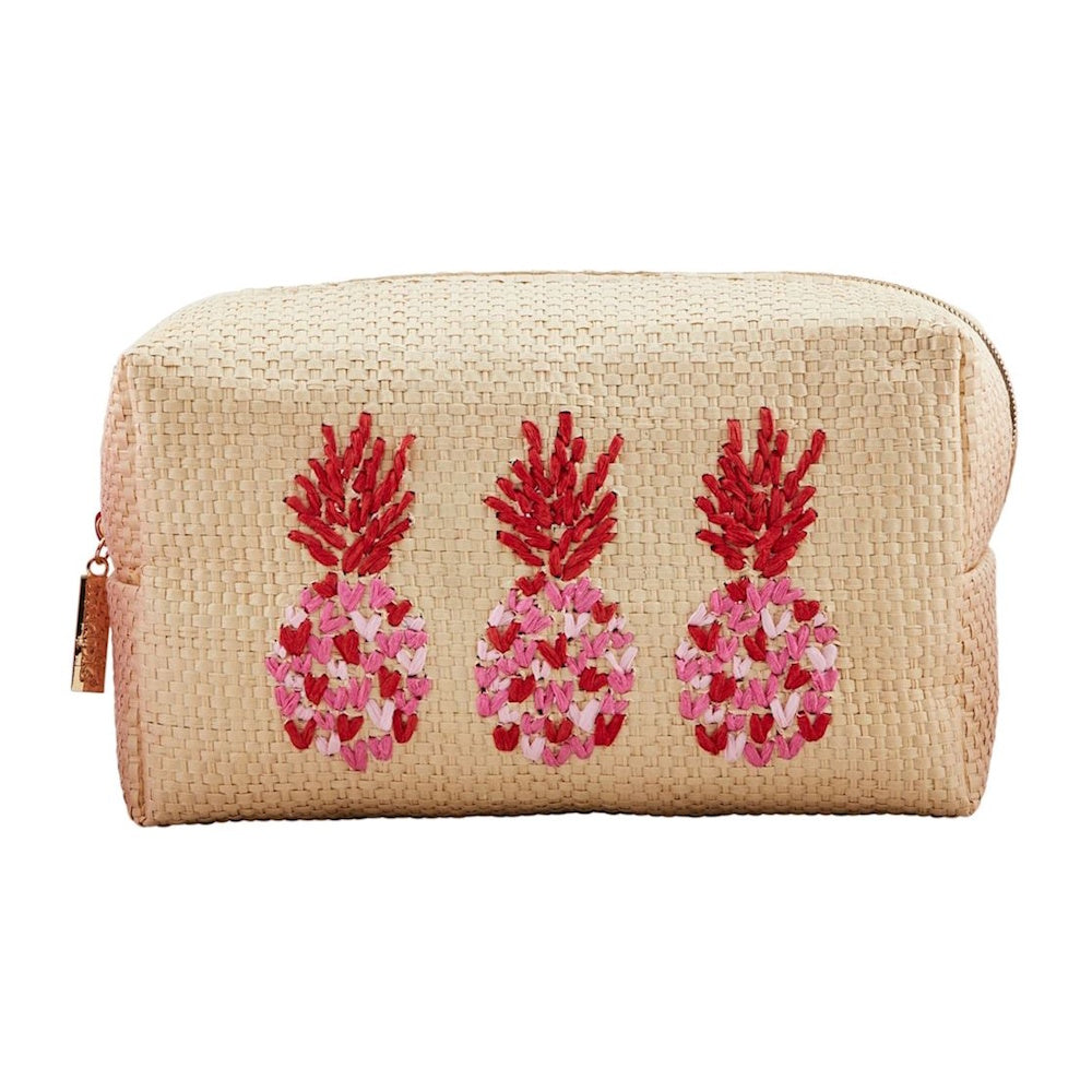 Woven straw makeup bag with three embroidered pink and red pineapples on the front.