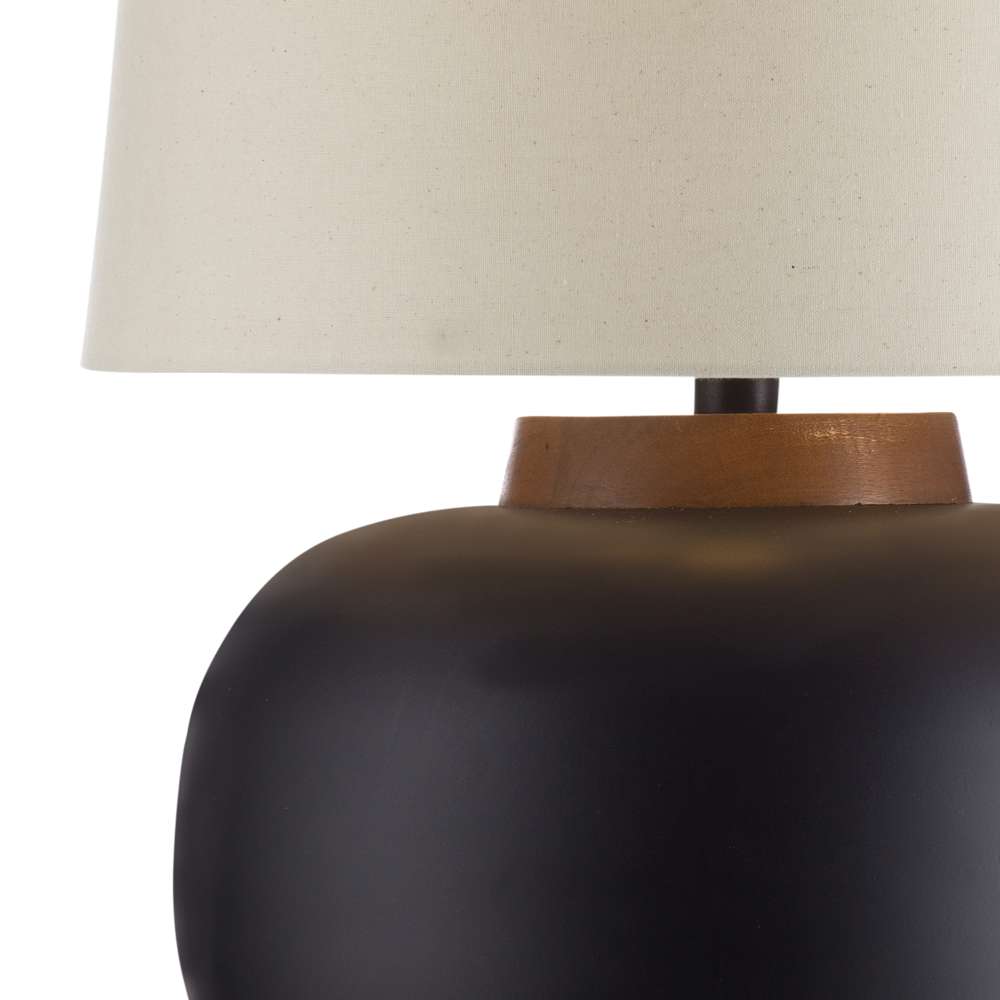 Modern matte black ceramic table lamp with a wood neck detail and off-white linen drum shade.