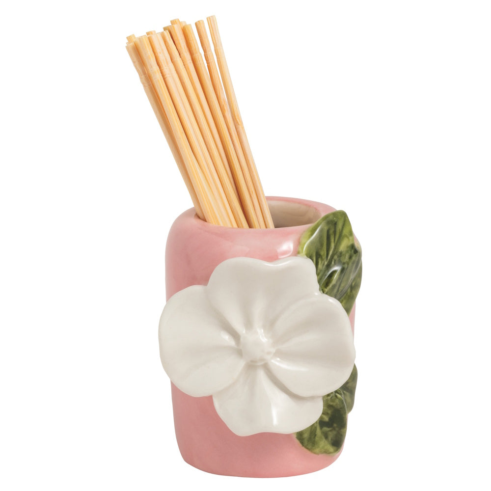 Small pink ceramic toothpick holder featuring a large white 3D flower and green leaves, filled with wooden toothpicks.