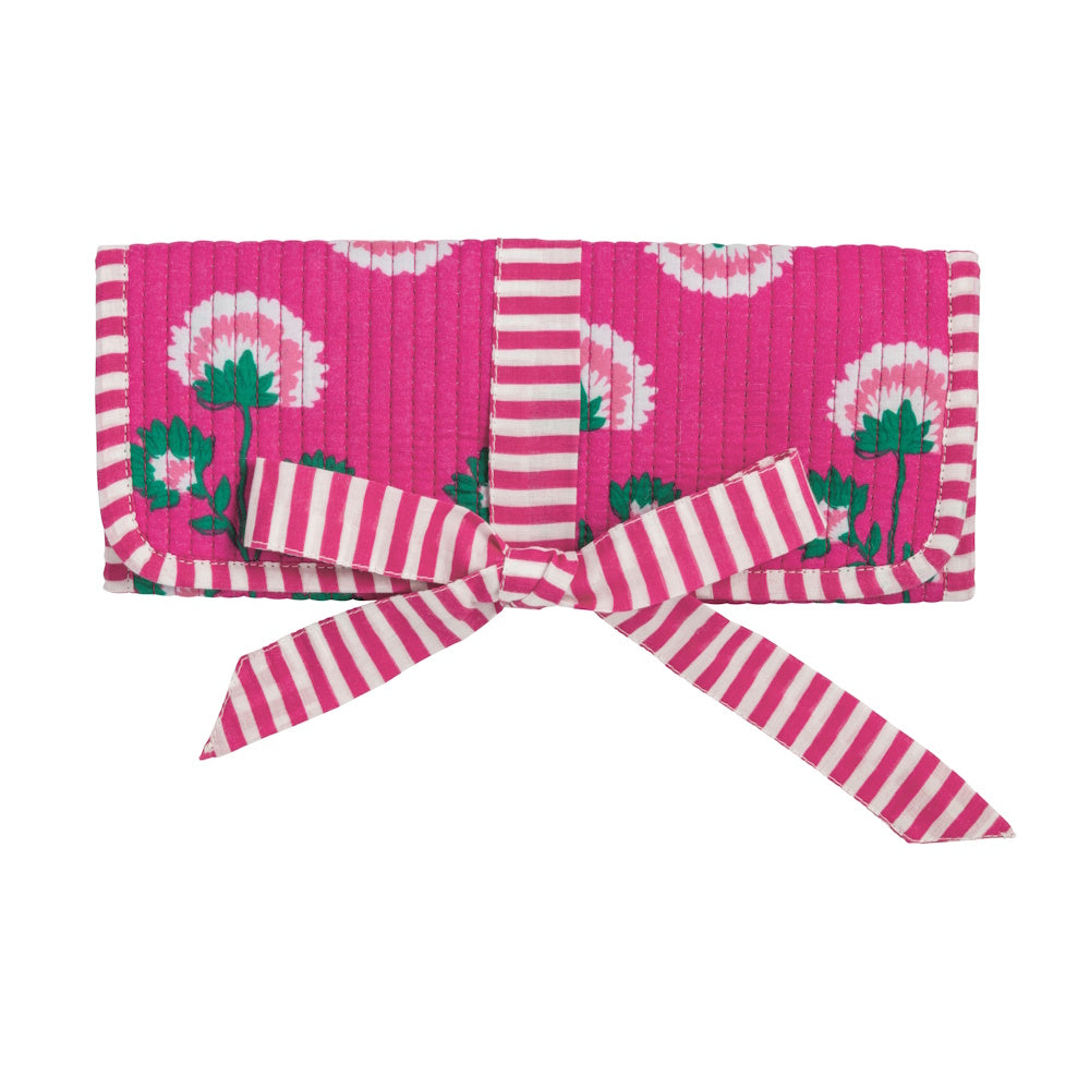 Hot pink floral block-print jewelry roll with matching pink striped ribbon tie closure on white background.