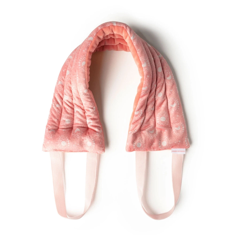 Lemon Lavender Hot Stuff heated neck wrap in pink with a white moon and sun pattern, featuring matching pink handles.