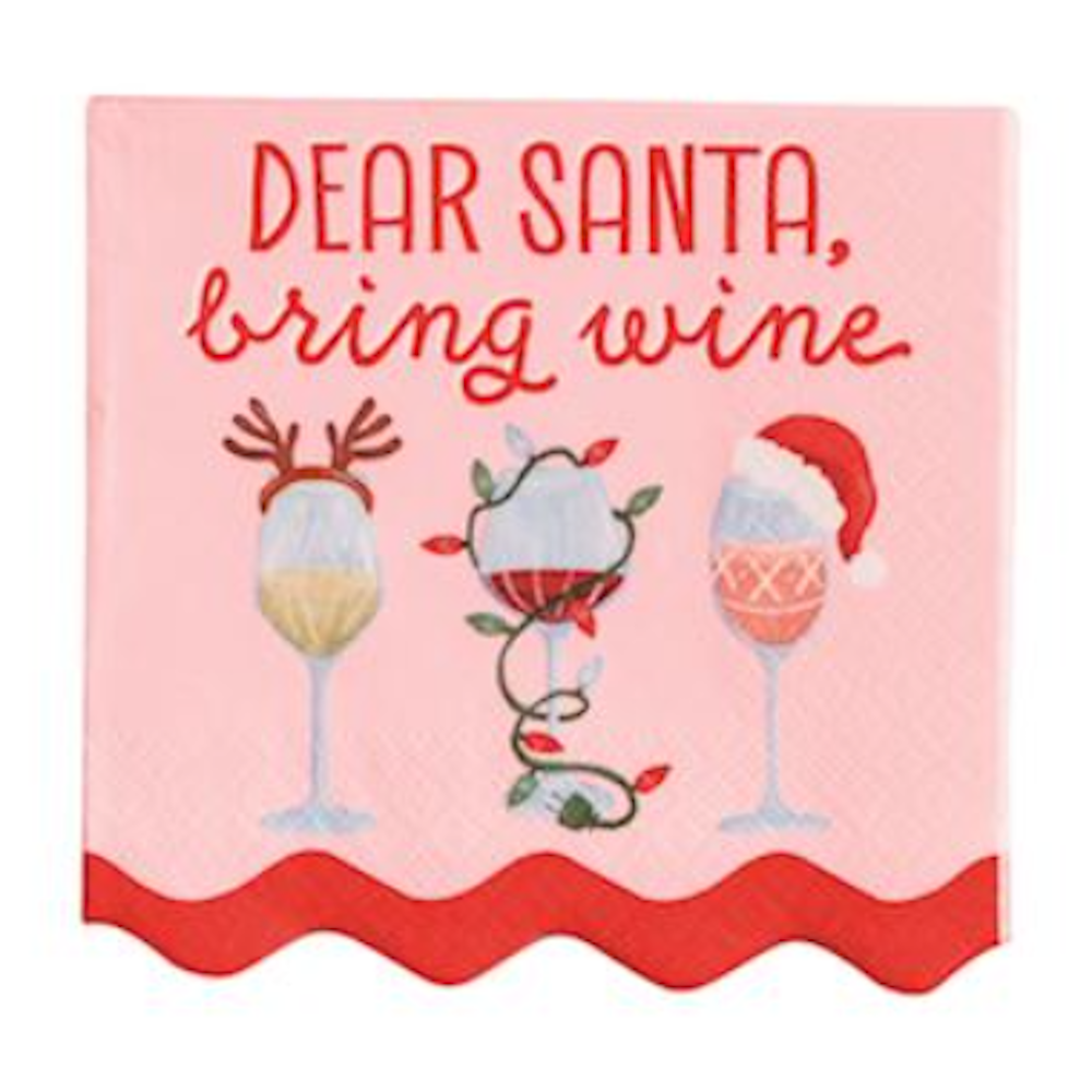 Pink napkin reading "Dear Santa, bring wine" above three decorated holiday wine glasses.