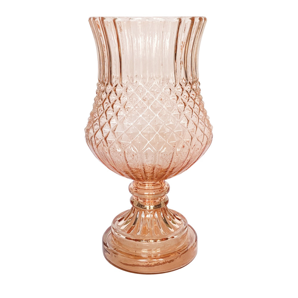 Pink embossed glass footed vase with a diamond texture and flared rim.