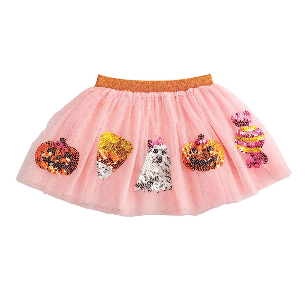 A pink tulle tutu skirt decorated with sequined Halloween figures including pumpkins, candy corn, and a ghost.