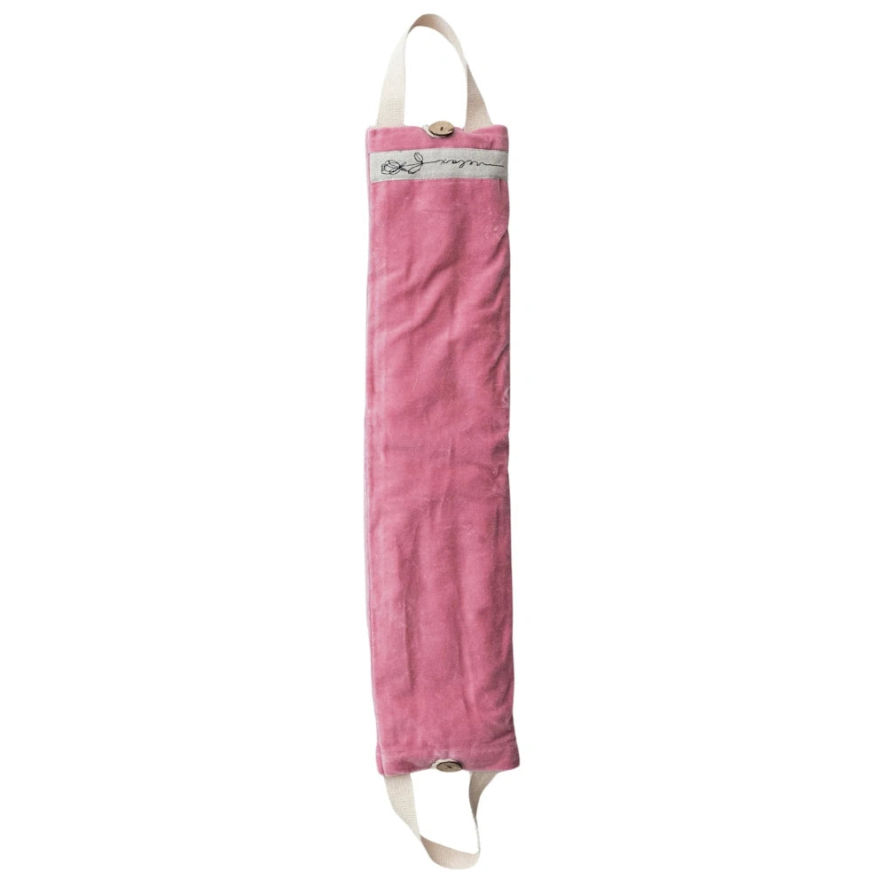 Pink velvet microwavable hot and cold neck wrap with cream hanging loops and button closures for therapeutic pain relief.
