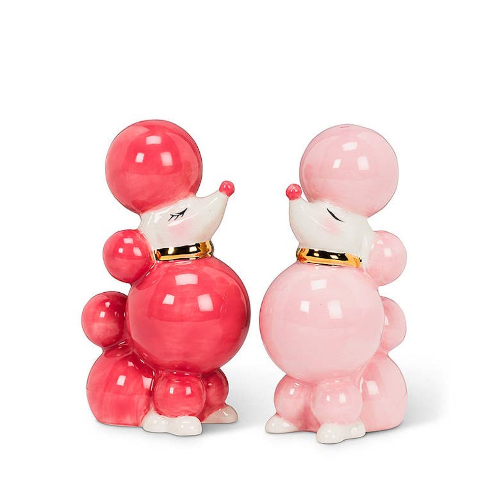 Vintage-style pink and dark pink ceramic poodle salt and pepper shakers with gold collars facing each other.