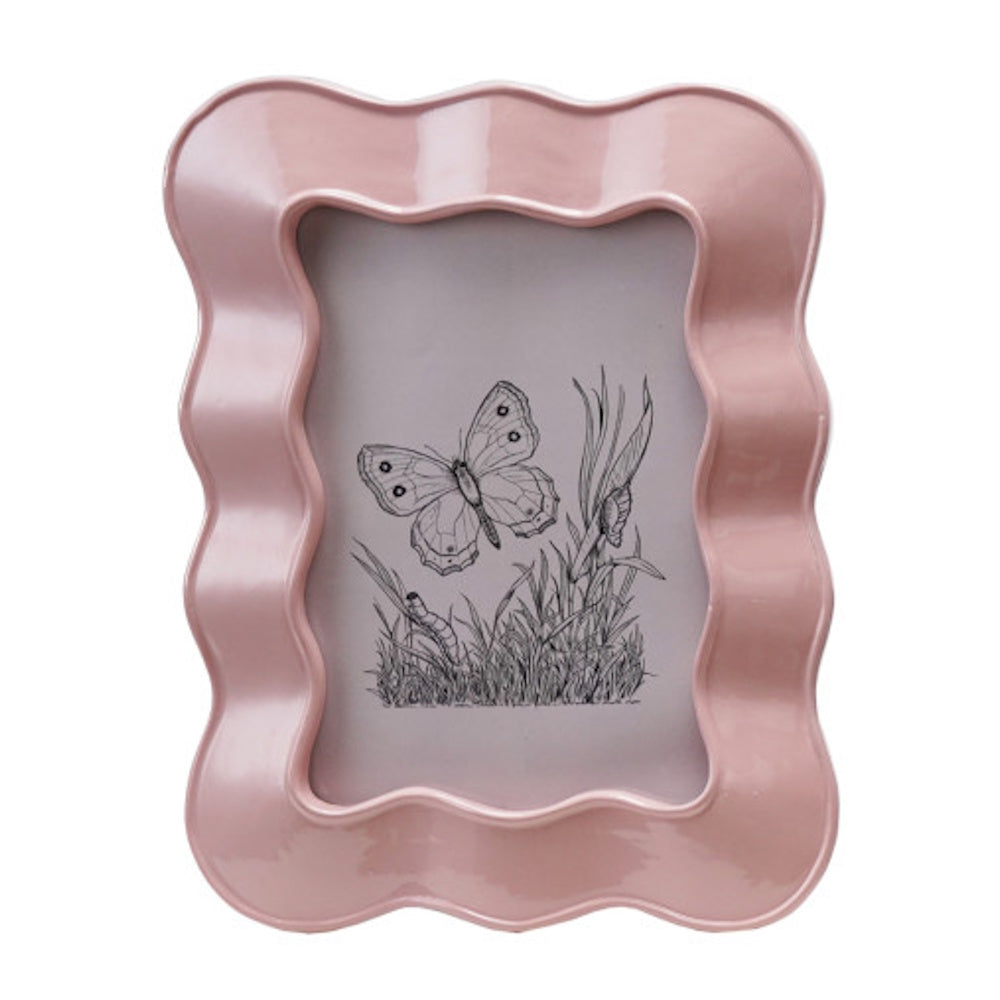 Pink wavy resin picture frame displaying a vintage black and white butterfly sketch.