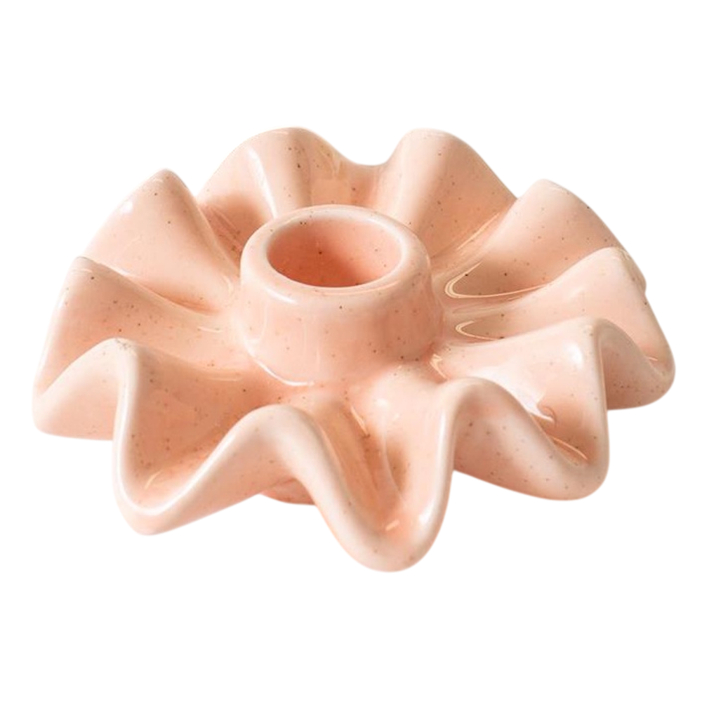 Light pink ceramic taper candle holder with a speckled glossy finish and ruffled edge.