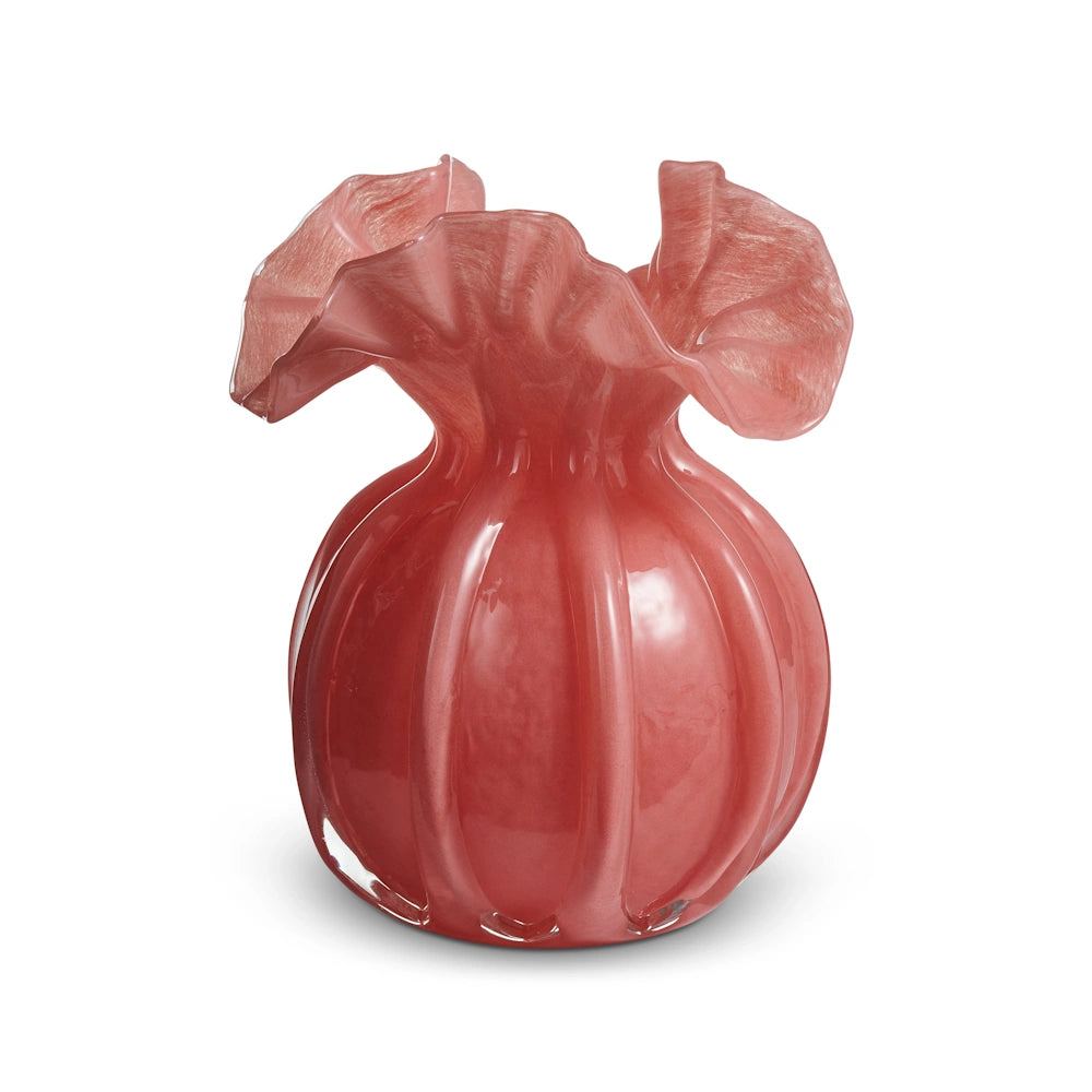 A pink, round glass vase with vertical ribs and a wide, ruffled rim against a white background.