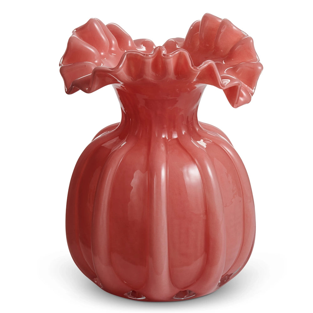 A pink, ribbed glass vase with a wide, ruffled rim against a white background.