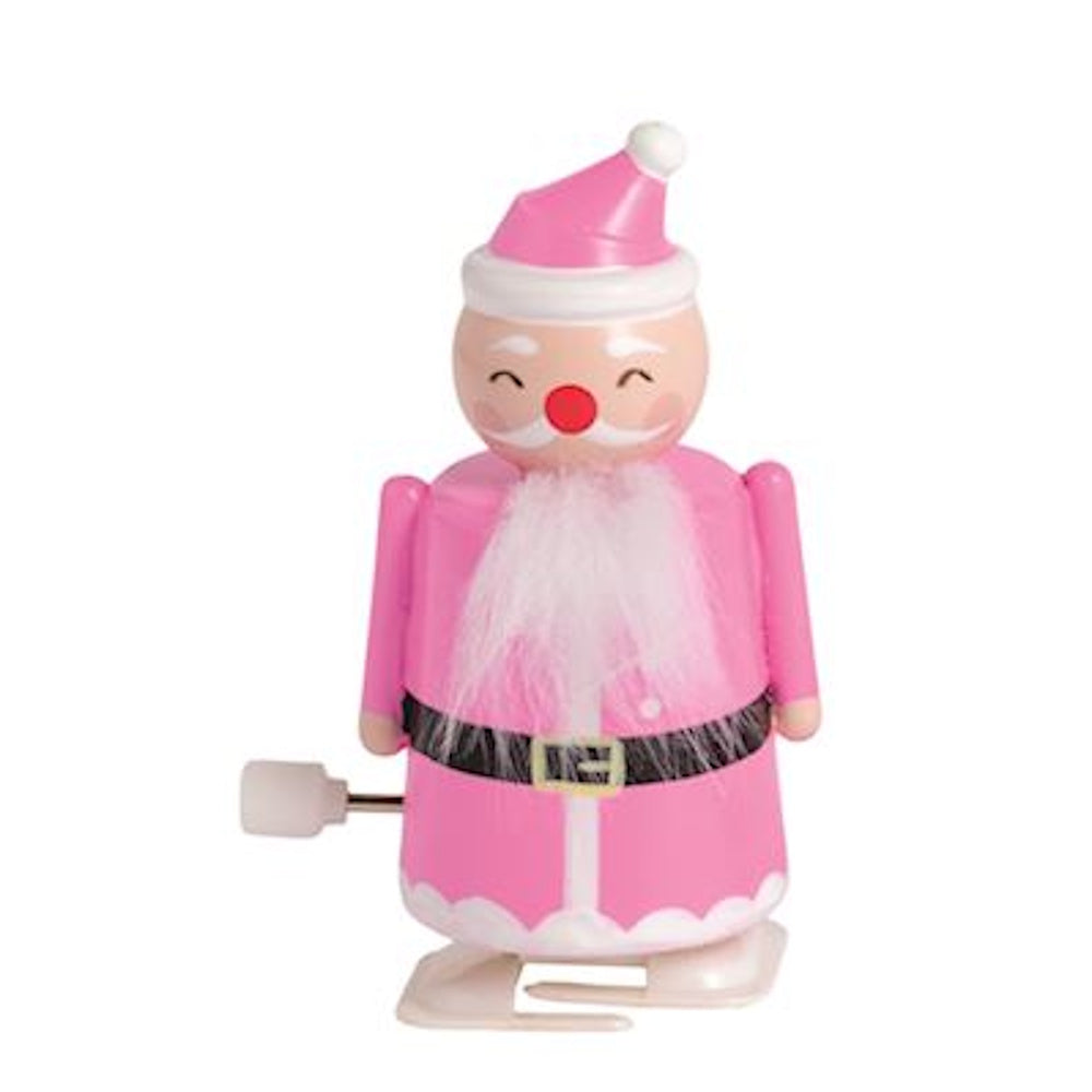 Pink wind-up Santa Claus toy with a white beard and hat on a plain background.