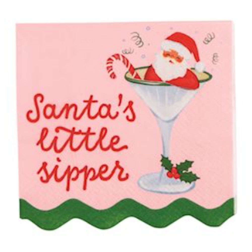 Pink napkin reading "Santa's little sipper" with Santa relaxing inside a martini glass.