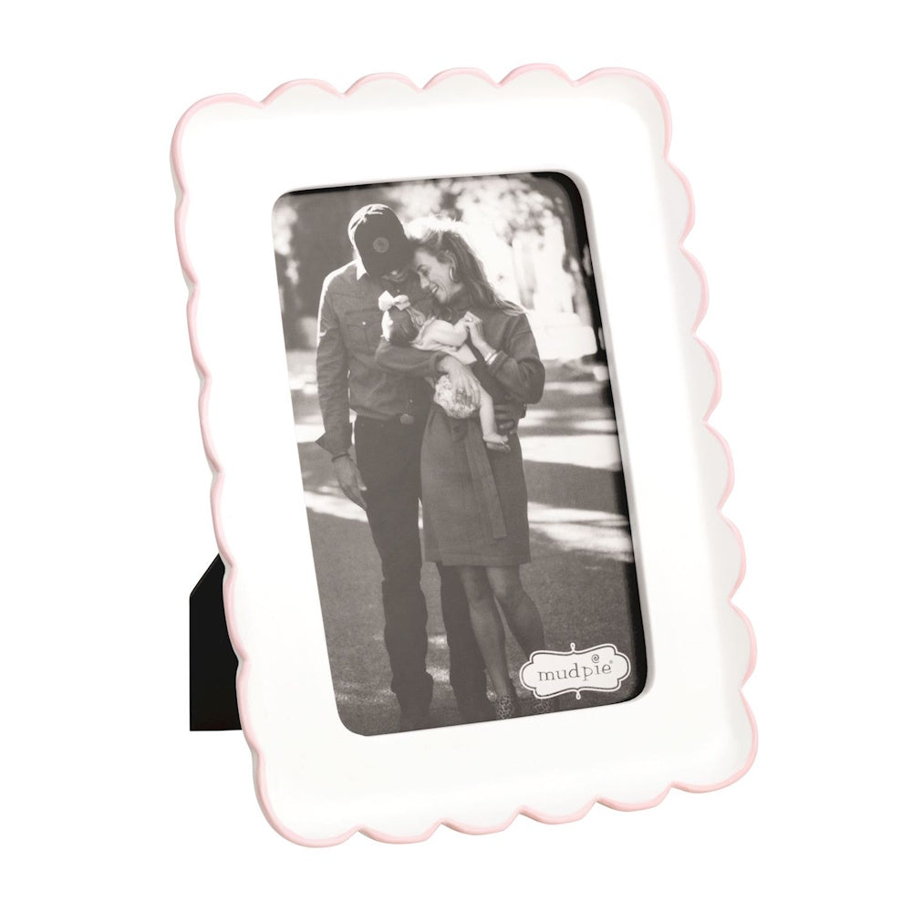 White Mud Pie picture frame with a pink scalloped edge, featuring a black and white family photo.