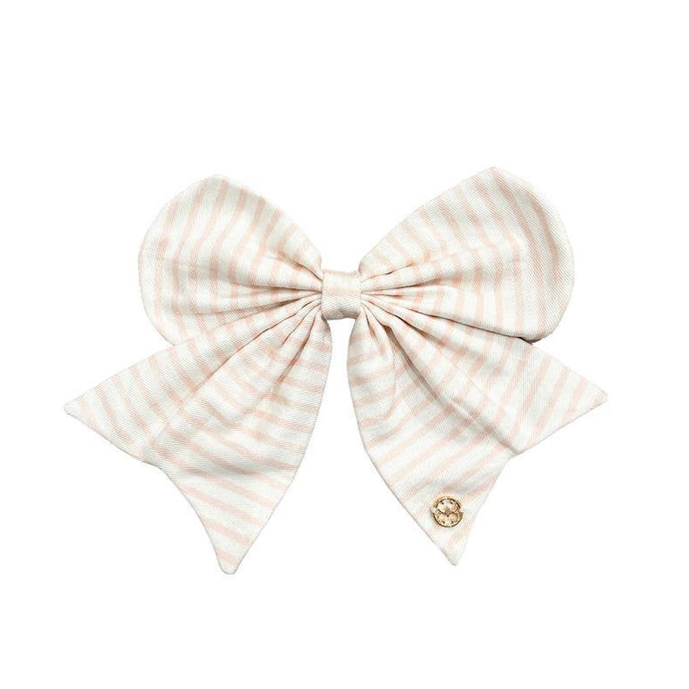 Light pink and white striped fabric hair bow with a small gold emblem on one tail.