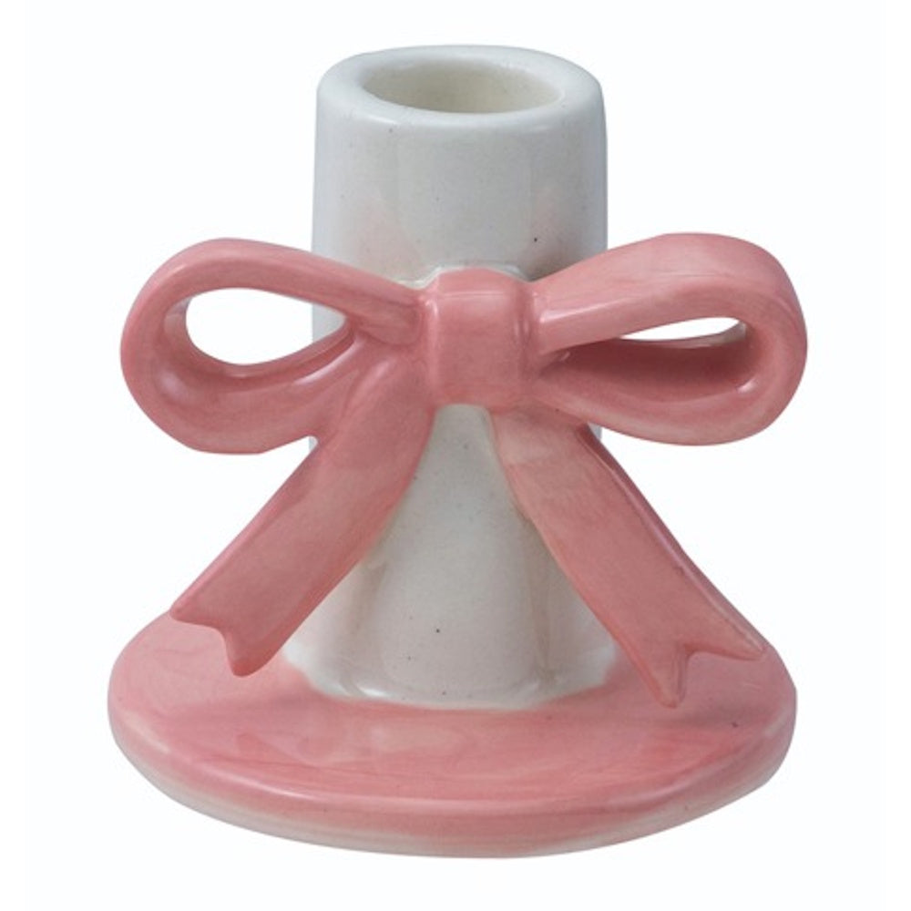 Pink and white stoneware taper candle holder featuring a three-dimensional pink bow on a white cylindrical neck.