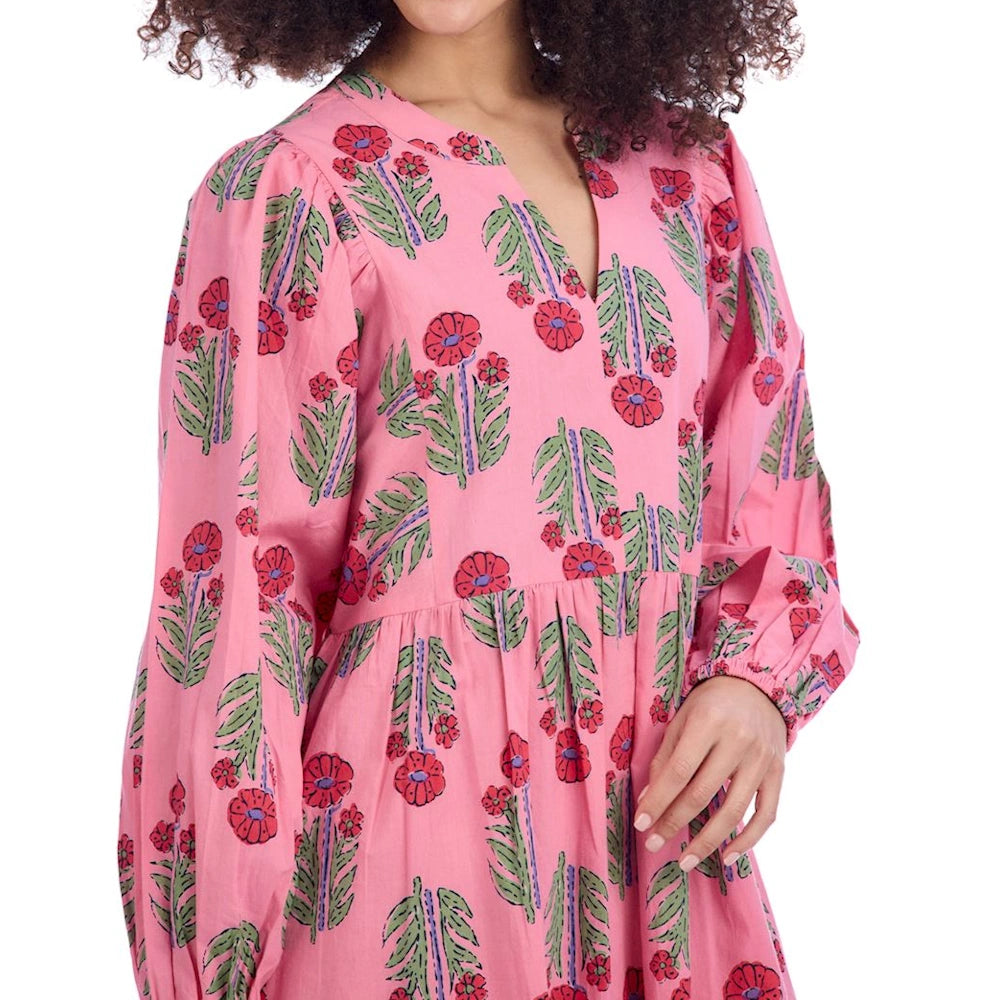 Pink midi dress with red and green floral block print, featuring a notched V-neckline, puff sleeves, and a tiered skirt.
