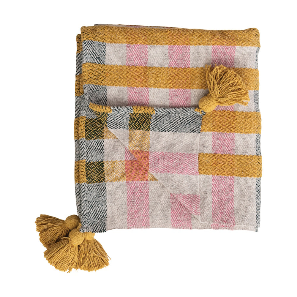 Plaid woven throw blanket in mustard yellow, pink, and grey with large corner tassels.
