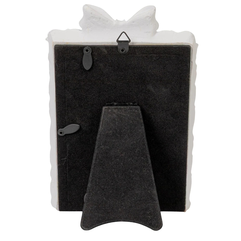 Back of a white bow photo frame with a black felt stand and hanging hook for desktop or wall display.