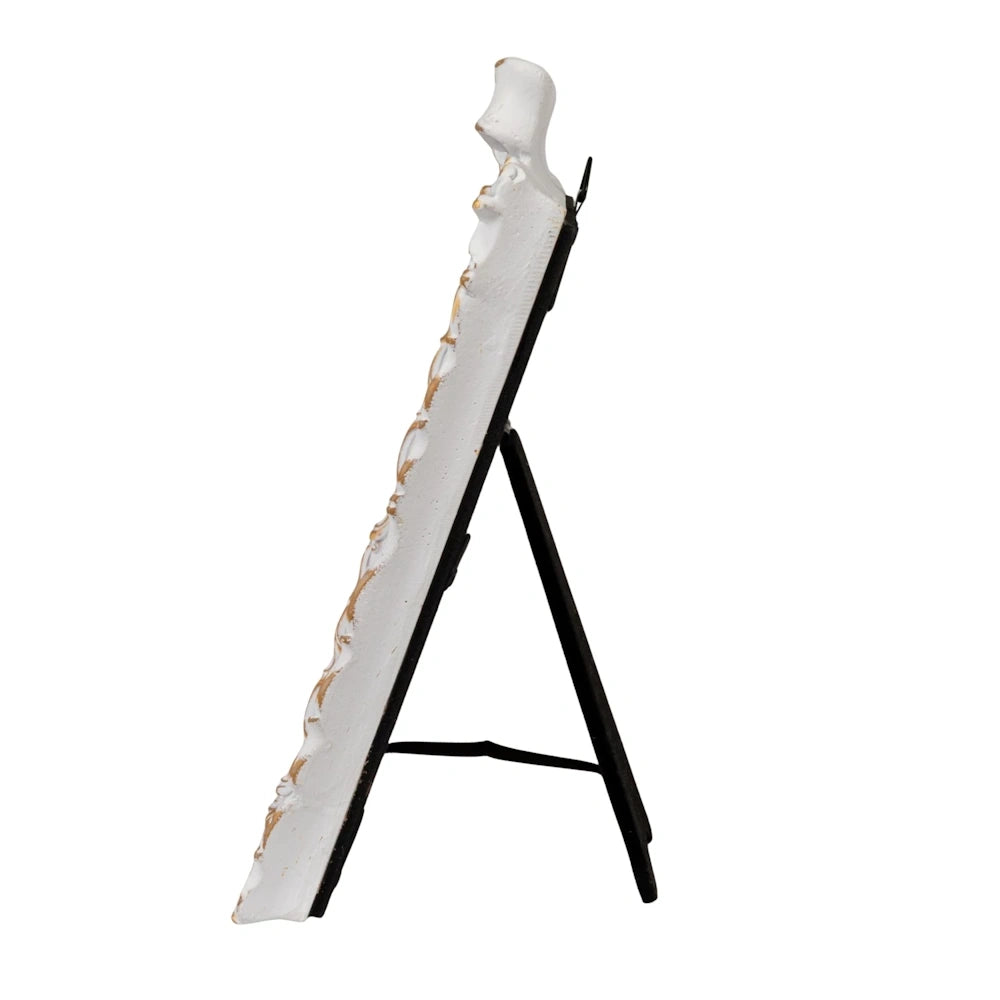 Side view of an ornate white and gold picture frame with a black easel stand, isolated on a white background.