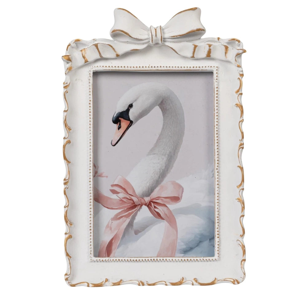 Vintage-style white bow picture frame featuring a swan with a pink ribbon. Elegant home decor and nursery wall art.