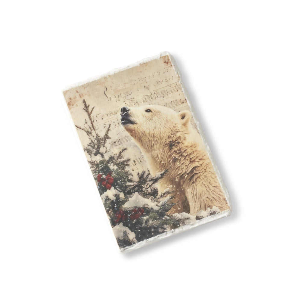 A soft-cover Christmas journal featuring a polar bear and a deckle edge against a vintage background.
