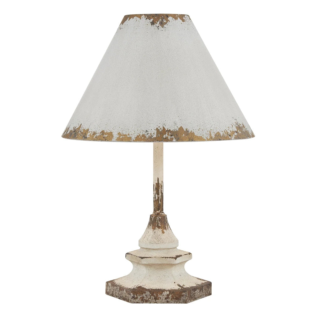Vintage distressed white metal table lamp with rustic weathered finish and conical shade on a white background.