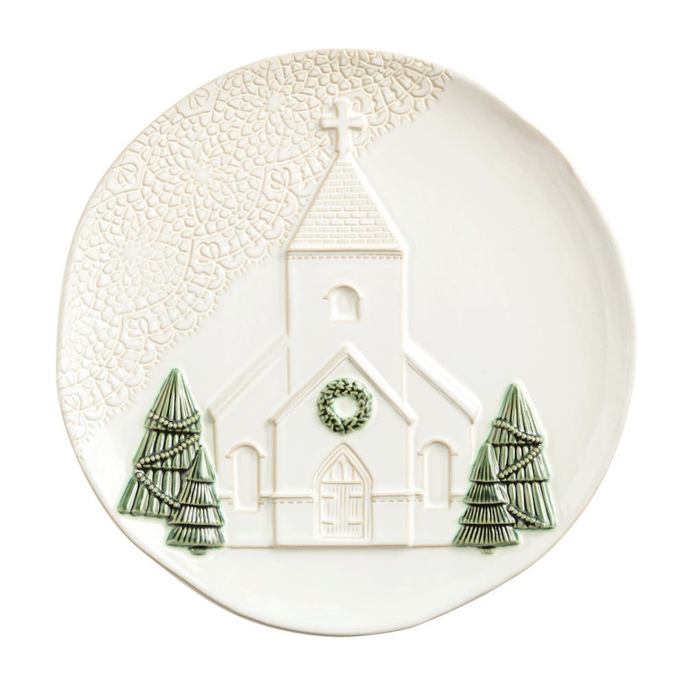 White ceramic platter with embossed church, green pine trees, wreath, and lace-textured border.